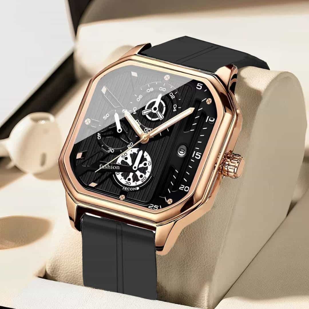 Rose-gold square watch with a black skeleton-style dial and black silicone strap on a cream pillow