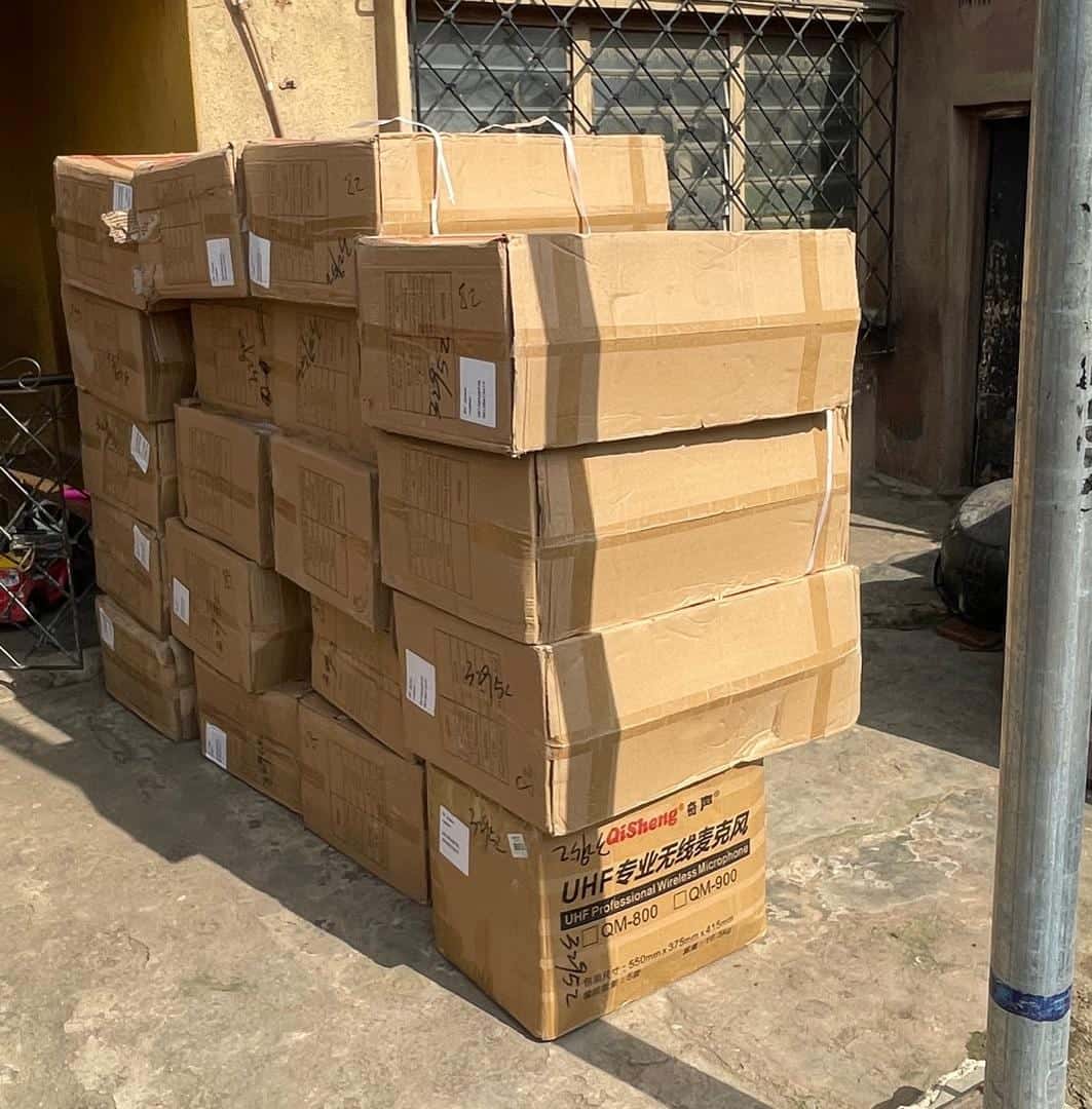 A stack of imported cartons outside a building